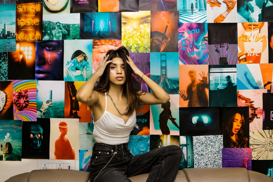 Girl posing in front of posters