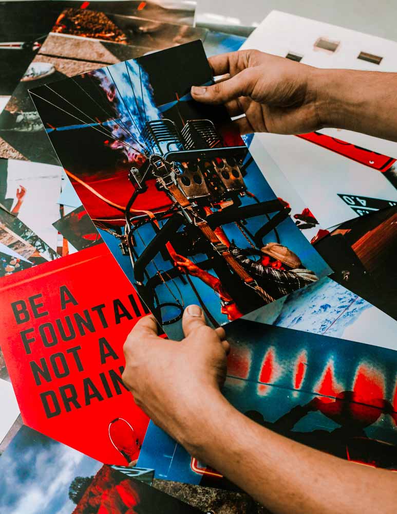 A guy holding a poster of a hot air balloon fire poster