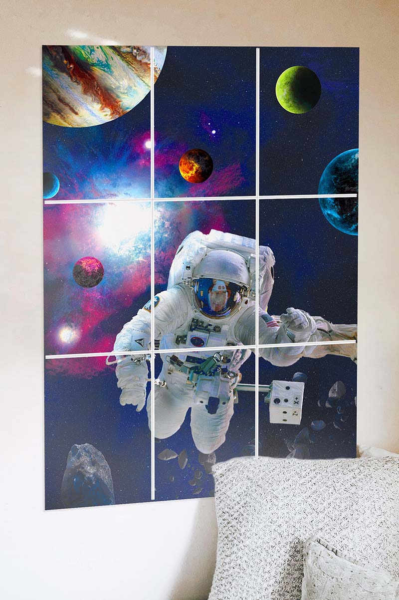 block kit astronaut poster on the wall next to a pillow